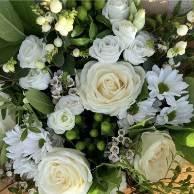 Florists Choice - Pure Elegance - An elegant arrangement of fresh white blooms and luxurious seasonal greenery, hand-selected by the experts. By leaving the choice to us, you’ll receive the freshest flowers available, beautifully styled into a timeless and sophisticated bouquet.